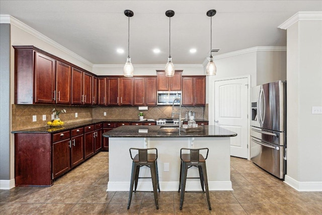 9520 Sydney Marilyn Ln, Austin, TX 78748 - kitchen featuring appliances with stainless steel finishes, decorative backsplash, tile patterned flooring, a center island with sink, and ornamental molding