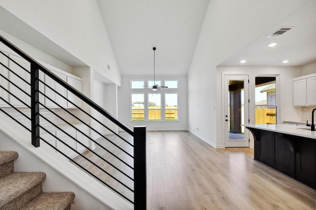 596 Biscayne Bay Bnd, Kyle, TX 78640 - stairs with a ceiling fan, high vaulted ceiling, plenty of natural light, wood finished floors, and recessed lighting