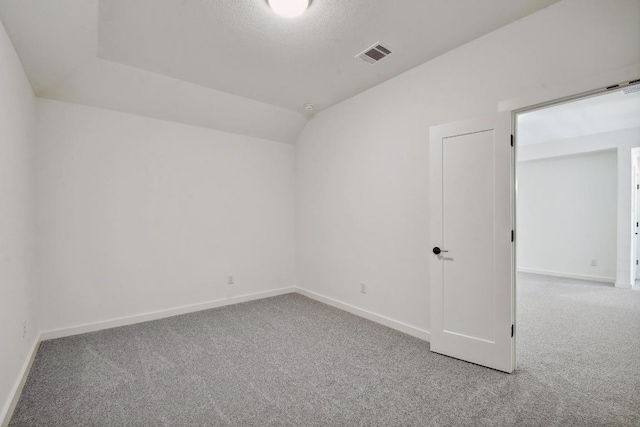 596 Biscayne Bay Bnd, Kyle, TX 78640 - carpeted spare room with baseboards and vaulted ceiling