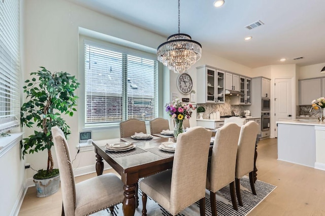 1505 Sibley Way, Leander, TX 78641 - dining room with recessed lighting, light wood finished floors, and a chandelier