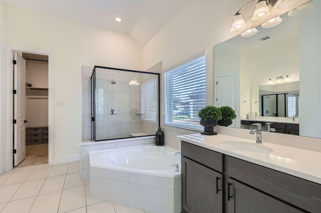 1505 Sibley Way, Leander, TX 78641 - full bathroom with a stall shower, a garden tub, vanity, tile patterned floors, and a walk in closet