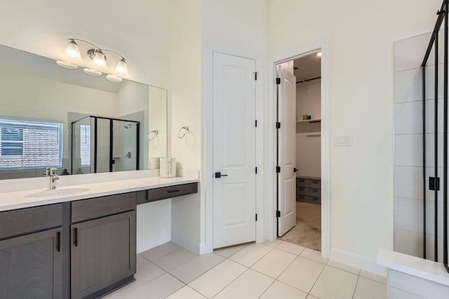 1505 Sibley Way, Leander, TX 78641 - full bathroom with tile patterned floors, a stall shower, a walk in closet, and vanity