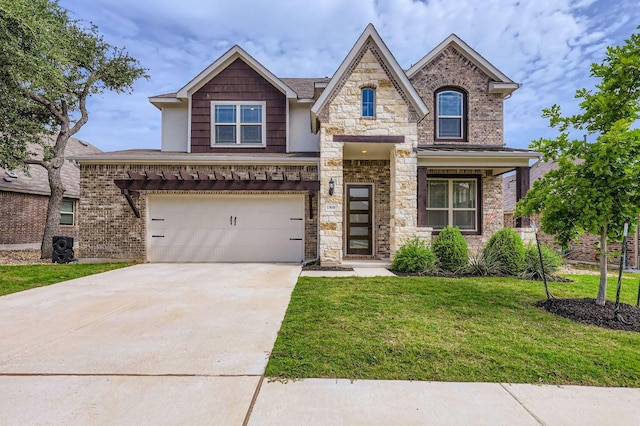 1505 Sibley Way, Leander, TX 78641 - view of front of home with concrete driveway, a front lawn, a garage, and stone siding