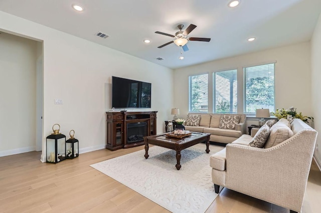 1505 Sibley Way, Leander, TX 78641 - living room with a ceiling fan, recessed lighting, light wood-type flooring, and a fireplace