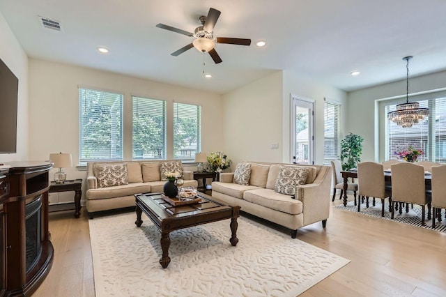 1505 Sibley Way, Leander, TX 78641 - living room featuring light wood finished floors, a chandelier, ceiling fan, and recessed lighting