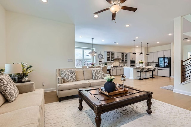 1505 Sibley Way, Leander, TX 78641 - living area featuring a ceiling fan, light wood finished floors, stairs, and recessed lighting