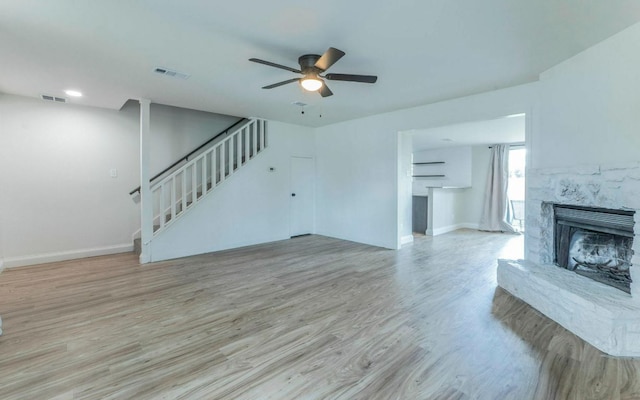 1623 Peachtree Valley Dr, Round Rock, TX 78681 - unfurnished living room with a ceiling fan, stairway, a fireplace, and wood finished floors