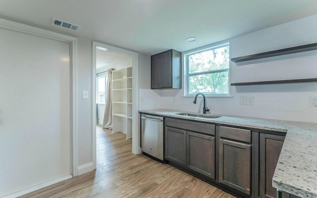 1623 Peachtree Valley Dr, Round Rock, TX 78681 - kitchen with stainless steel dishwasher, open shelves, and light wood-style floors