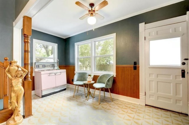 200 Garwood St, Smithville, TX 78957 - sitting room featuring tile patterned floors, a wainscoted wall, a ceiling fan, crown molding, and wooden walls