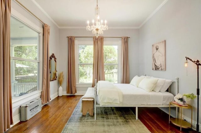 200 Garwood St, Smithville, TX 78957 - bedroom with wood finished floors, a chandelier, and crown molding