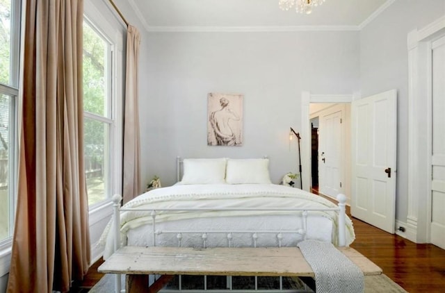 200 Garwood St, Smithville, TX 78957 - bedroom with wood finished floors, crown molding, and a chandelier