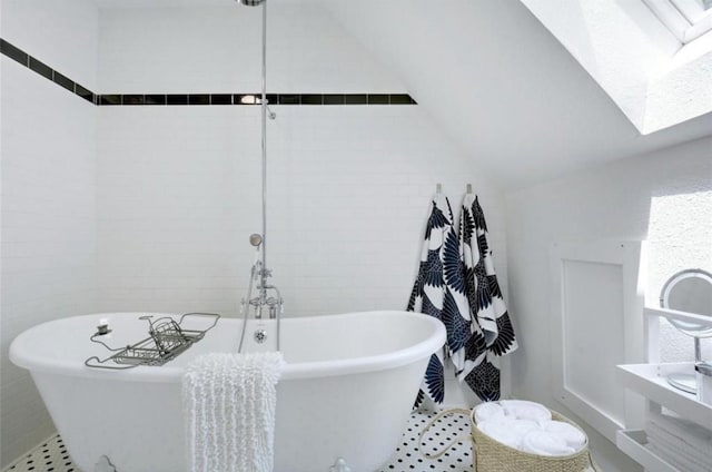 200 Garwood St, Smithville, TX 78957 - full bath with a skylight, a freestanding tub, and lofted ceiling