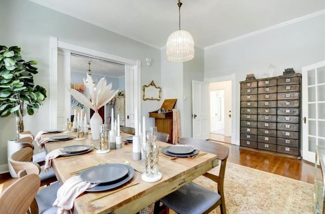 200 Garwood St, Smithville, TX 78957 - dining room featuring a chandelier, wood finished floors, and ornamental molding