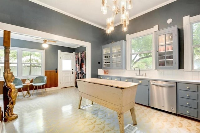 200 Garwood St, Smithville, TX 78957 - kitchen featuring stainless steel dishwasher, gray cabinets, light flooring, wainscoting, and healthy amount of natural light