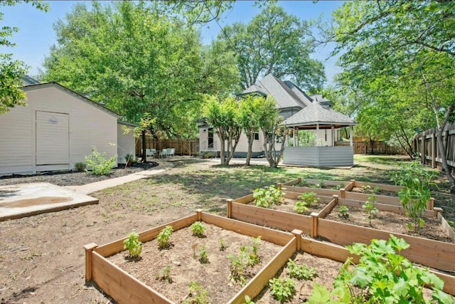 200 Garwood St, Smithville, TX 78957 - fenced backyard with a gazebo, a garden, and an outbuilding