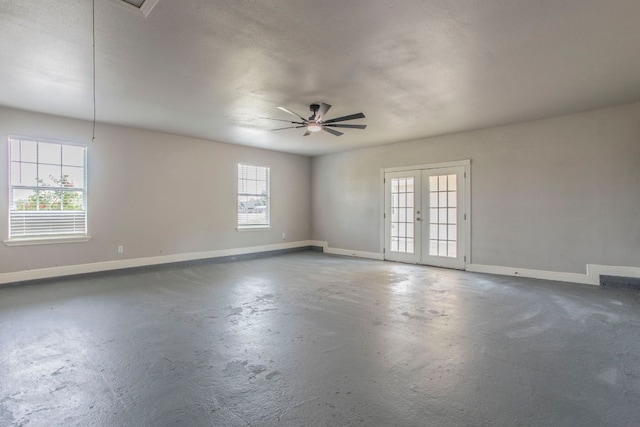 14596 Touchstone Rd Unit 3, Atascosa, TX 78002 - empty room with french doors, concrete flooring, and a ceiling fan