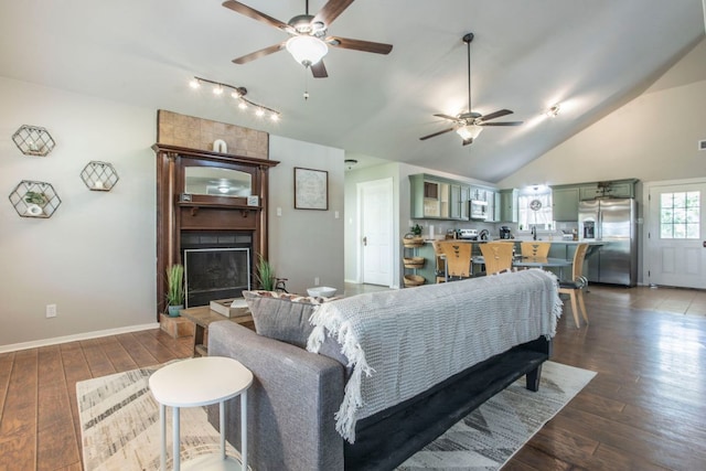 14596 Touchstone Rd Unit 3, Atascosa, TX 78002 - living room with a ceiling fan, dark wood-type flooring, a large fireplace, lofted ceiling, and track lighting