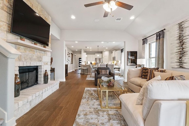 113 Charro Ct, Georgetown, TX 78633 - living room with ceiling fan, dark wood-style floors, a stone fireplace, recessed lighting, and vaulted ceiling