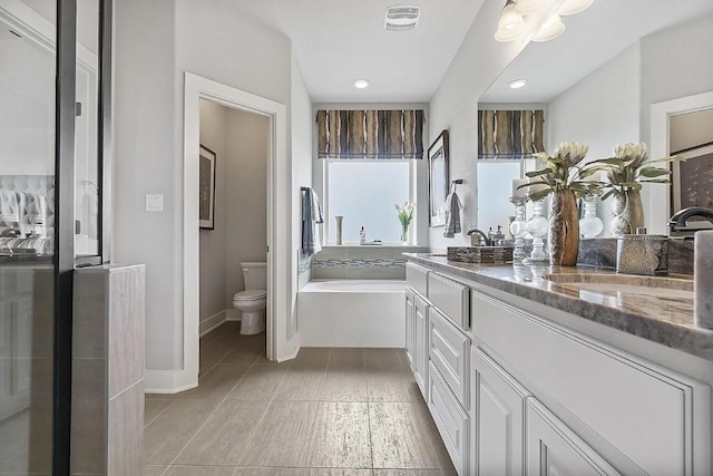 113 Charro Ct, Georgetown, TX 78633 - full bath with double vanity, a garden tub, tile patterned floors, and recessed lighting