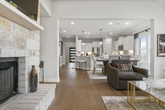 113 Charro Ct, Georgetown, TX 78633 - living room with dark wood-style flooring, recessed lighting, and a stone fireplace