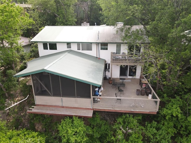 3309 Westhill Unit A & B, Austin, TX 78704 - back of property with a balcony, a chimney, outdoor dining area, a sunroom, and a metal roof