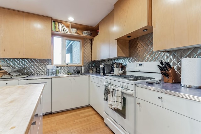 3309 Westhill Unit A & B, Austin, TX 78704 - kitchen featuring white gas range oven, stainless steel countertops, light wood finished floors, and backsplash