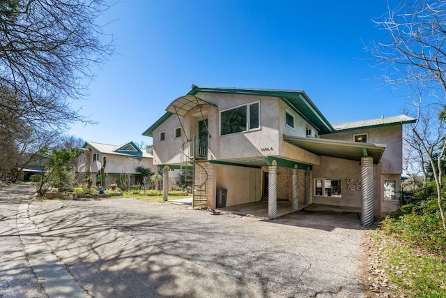 3309 Westhill Unit A & B, Austin, TX 78704 - view of front of home with stucco siding, asphalt driveway, a carport, and stairs