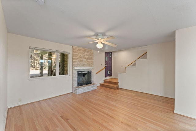 3309 Westhill Unit A & B, Austin, TX 78704 - unfurnished living room with light wood-style floors, ceiling fan, stairs, and a large fireplace