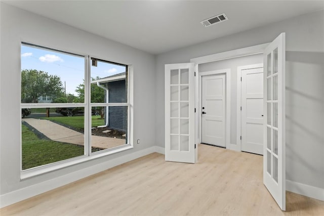 3907 Carmel Dr, Austin, TX 78721 - empty room with french doors and light wood-type flooring