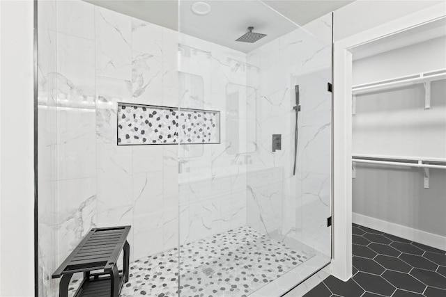 3907 Carmel Dr, Austin, TX 78721 - full bathroom featuring a marble finish shower, a spacious closet, and tile patterned floors