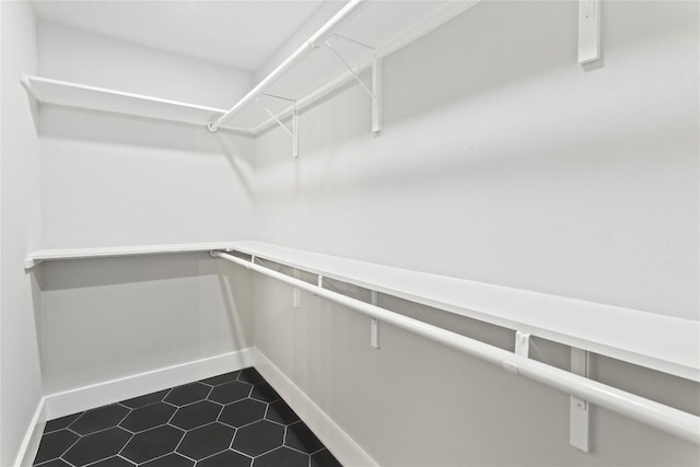 3907 Carmel Dr, Austin, TX 78721 - walk in closet featuring dark tile patterned flooring