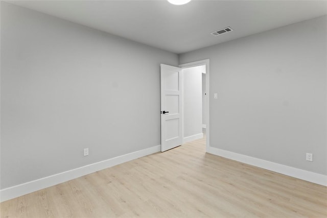 3907 Carmel Dr, Austin, TX 78721 - unfurnished room with baseboards and light wood-style flooring
