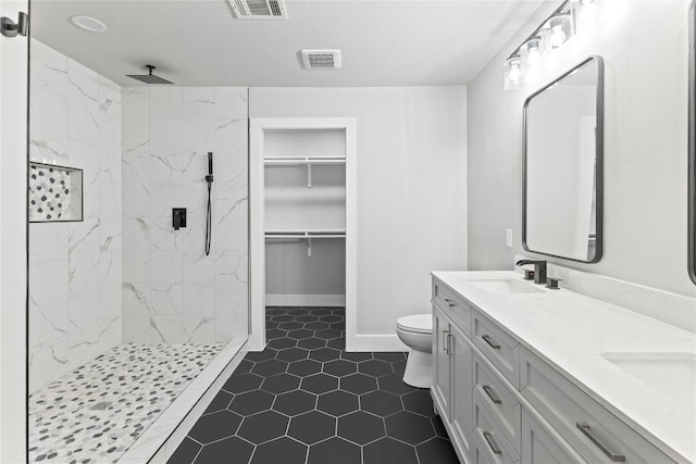 3907 Carmel Dr, Austin, TX 78721 - full bath with a marble finish shower, double vanity, and tile patterned floors