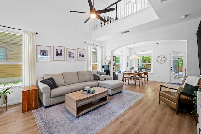1620 Rockland Dr Unit 167, Austin, TX 78748 - living room with arched walkways, light wood-type flooring, ceiling fan, and a high ceiling