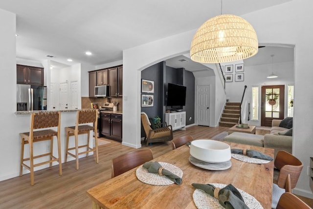 1620 Rockland Dr Unit 167, Austin, TX 78748 - living area featuring light wood finished floors, stairway, arched walkways, and recessed lighting