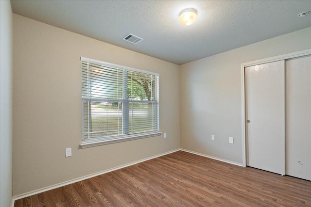 11617 Briarcreek Loop, Manor, TX 78653 - unfurnished bedroom with wood finished floors and a closet