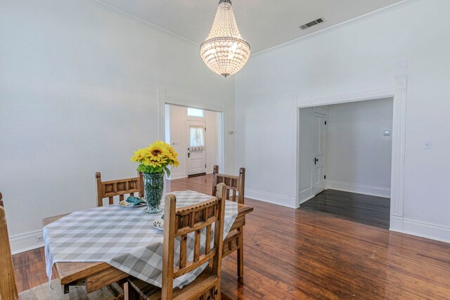 618 N Penelope St, Belton, TX 76513 - dining area featuring a chandelier, wood finished floors, and ornamental molding