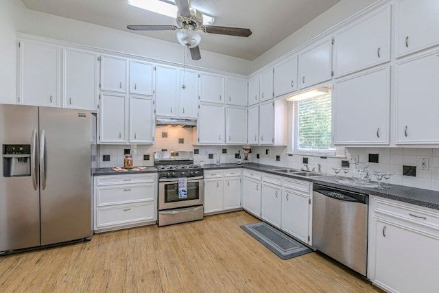 618 N Penelope St, Belton, TX 76513 - kitchen featuring appliances with stainless steel finishes, under cabinet range hood, dark countertops, and white cabinetry