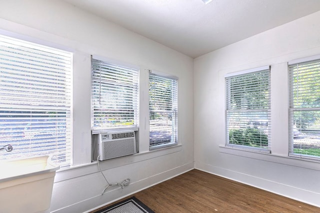618 N Penelope St, Belton, TX 76513 - empty room with dark wood finished floors and cooling unit
