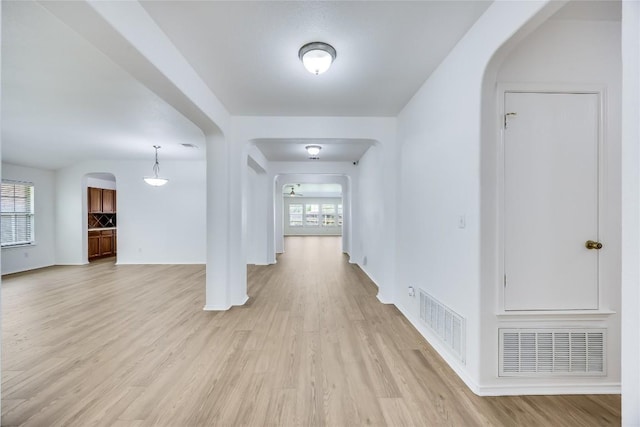 19700 San Chisolm Dr, Round Rock, TX 78664 - hallway featuring arched walkways and light wood-style floors