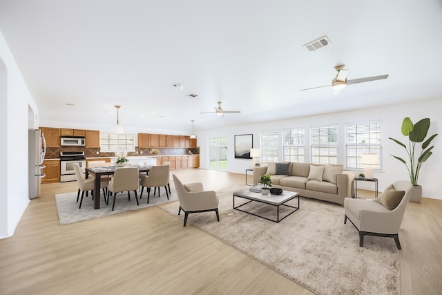 19700 San Chisolm Dr, Round Rock, TX 78664 - living area with a ceiling fan, plenty of natural light, and light wood-style flooring