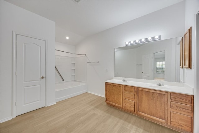 19700 San Chisolm Dr, Round Rock, TX 78664 - bathroom with double vanity, wood finished floors, shower / bath combination, and recessed lighting