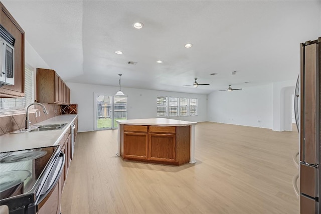 19700 San Chisolm Dr, Round Rock, TX 78664 - kitchen with light wood-style floors, appliances with stainless steel finishes, recessed lighting, a ceiling fan, and light countertops
