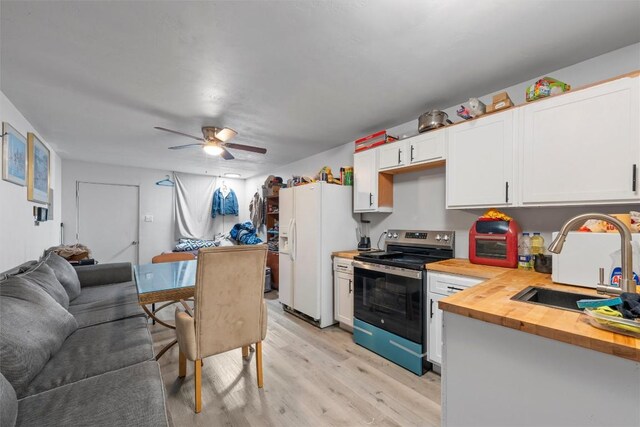 1211 S 17th St, Temple, TX 76504 - kitchen with stainless steel range with electric cooktop, butcher block counters, white fridge with ice dispenser, open floor plan, and light wood-type flooring