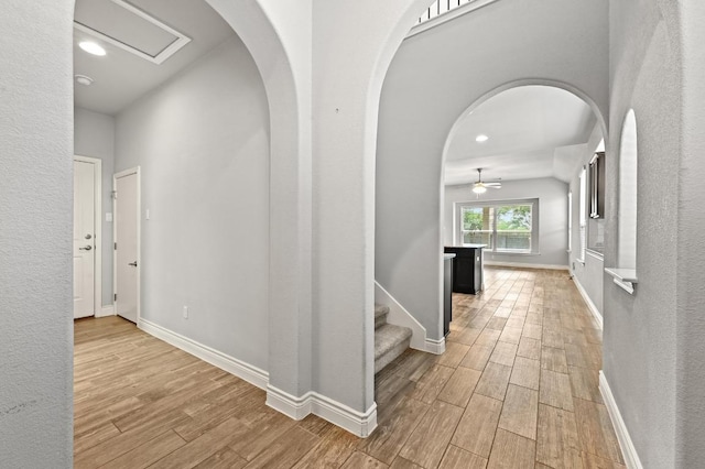 19113 Melwas Way, Pflugerville, TX 78660 - corridor featuring light wood-type flooring, arched walkways, and recessed lighting