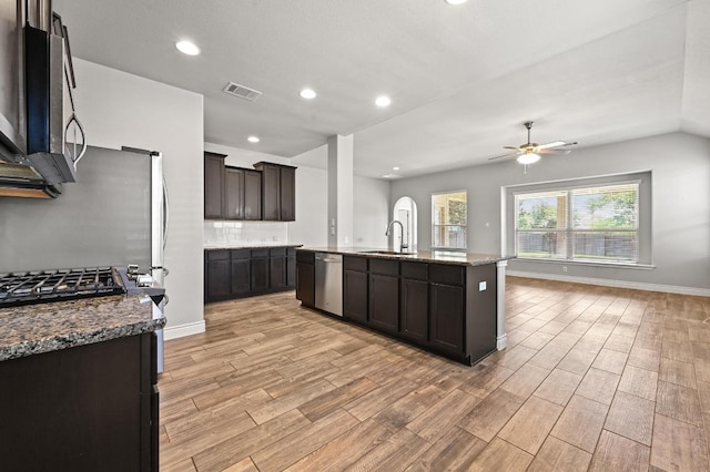 19113 Melwas Way, Pflugerville, TX 78660 - kitchen featuring stainless steel appliances, a ceiling fan, light wood-style flooring, stone counters, and recessed lighting