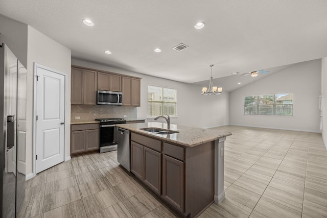 205 Falkland St, Hutto, TX 78634 - kitchen with stainless steel appliances, tasteful backsplash, recessed lighting, a kitchen island with sink, and a chandelier