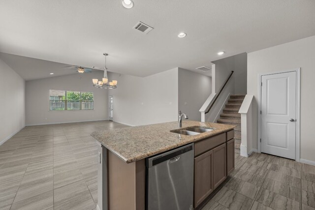 205 Falkland St, Hutto, TX 78634 - kitchen featuring stainless steel dishwasher, open floor plan, vaulted ceiling, recessed lighting, and light stone countertops