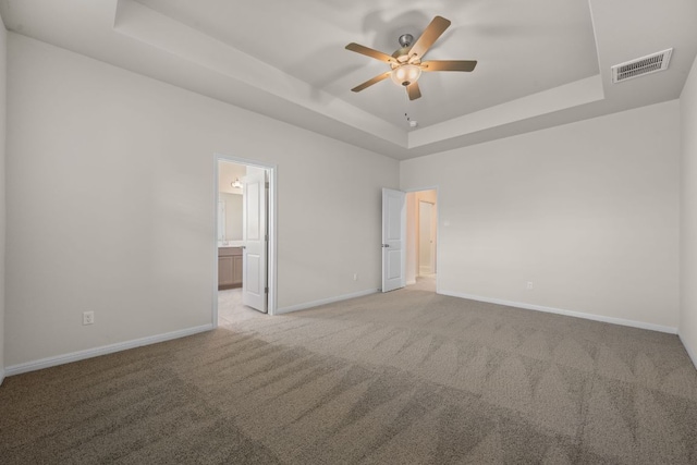205 Falkland St, Hutto, TX 78634 - unfurnished room with a tray ceiling, carpet floors, and ceiling fan