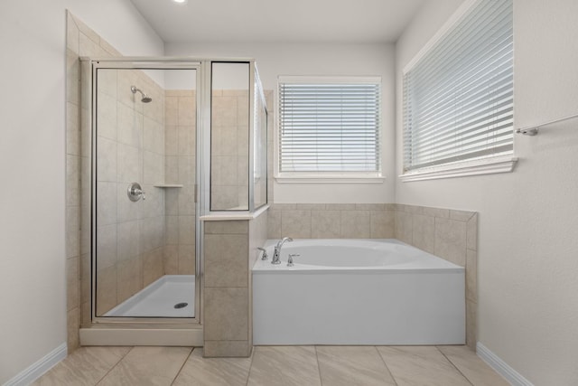 205 Falkland St, Hutto, TX 78634 - bathroom featuring a bath, a shower stall, and tile patterned floors